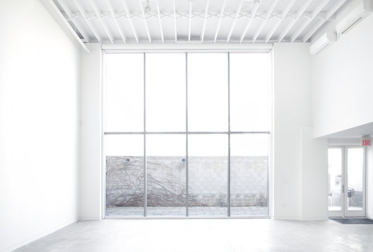 photo studio with white walls and floor to ceiling windows