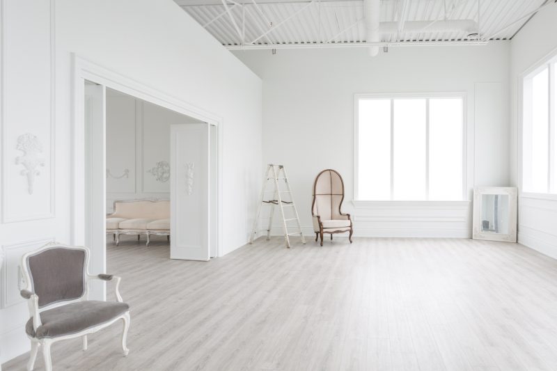 chic photo studio with wood floors and white walls