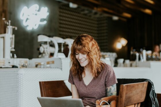 woman using a computer to play slot games online