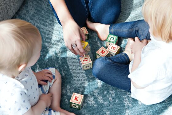 photo of two kids and caregiver for babysitting article