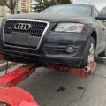 Grey audi car being sold and towed away