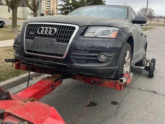 Grey audi car being sold and towed away