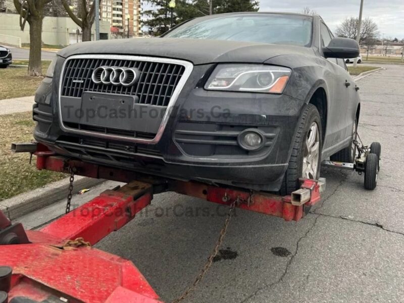 Grey audi car being sold and towed away
