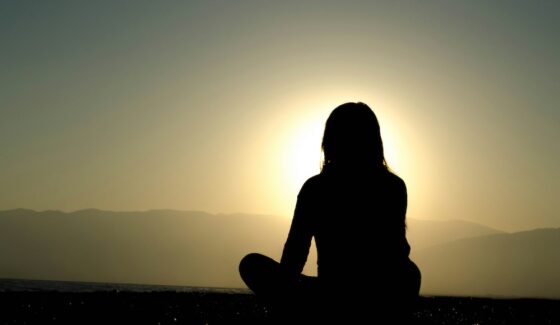 Woman in front of sunset