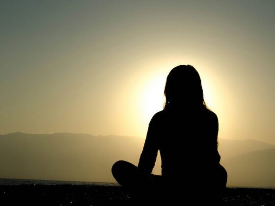 Woman in front of sunset