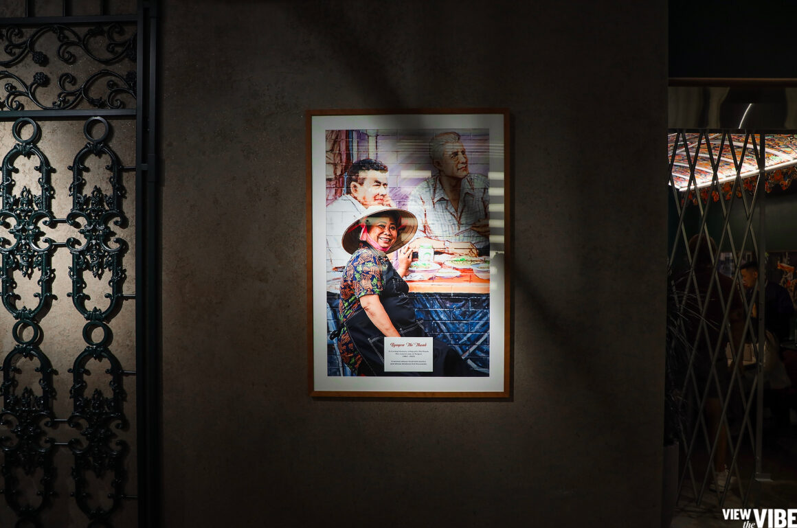 Portrait of the late Lunch Lady herself, next to a mural of Bourdain outside of the Lunch Lady Vancouver location, hung in the dining room. (Photo: Steven Branco for View the VIBE)