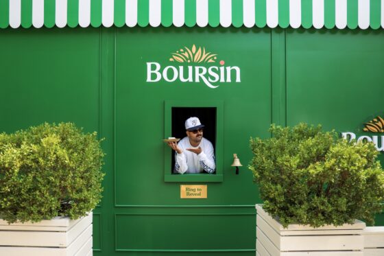 Chef Laurent Dagenais Boursin activation in Toronto giving away free cheese boards from a cheese window on Queen St W