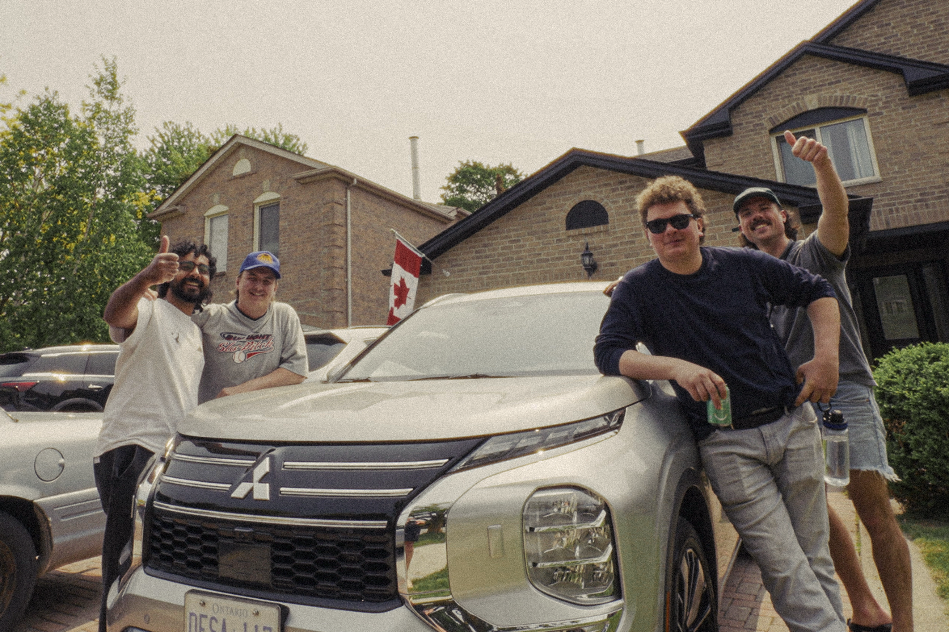 Rubber Tire Peep Show with the Mitsubishi Outlander — the ultimate Canadian road trip SUV — parked in the driveway before hitting the road for their 14,000 km cross-country tour.