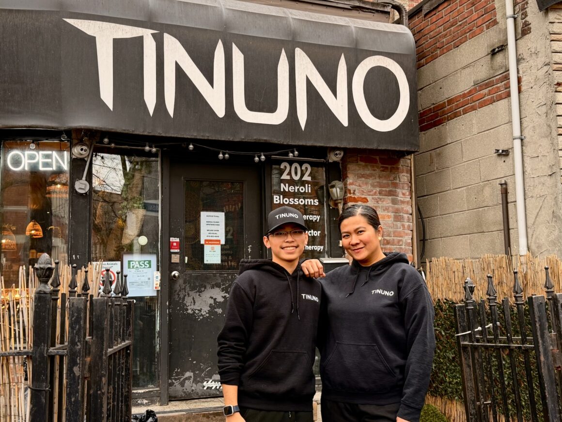 Tinuno general manager, Joy Narvaez (right) and server, Aaron Cruzado, standing proudly outside the newly refreshed Tinuno restaurant at 31 Howard Street, this morning of December 18, 2025 when they reopened. (Photo: Steven Branco for View the VIBE)
